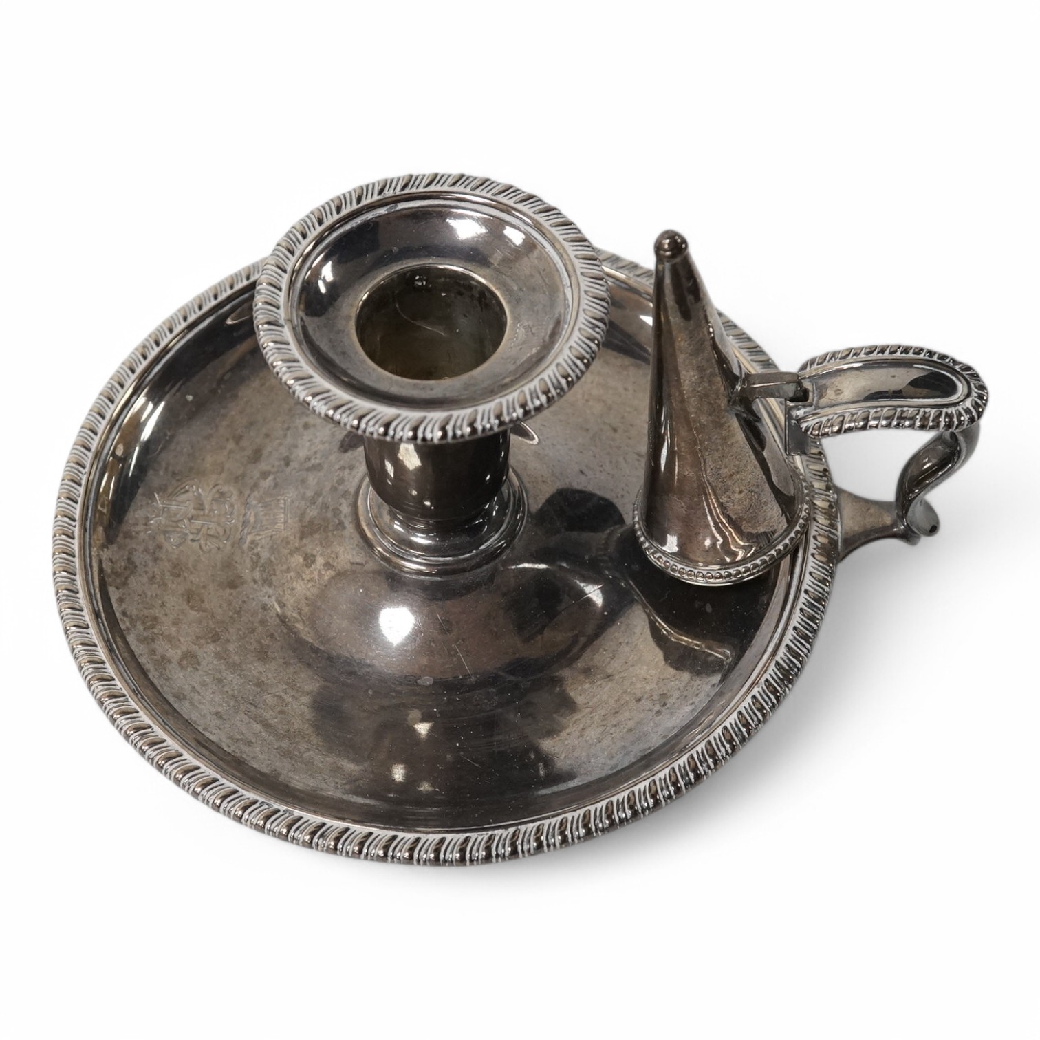 A late Victorian silver chamber stick, by Martin Goldstein, London, 1883, with associated silver extinguisher, base diameter 14.2cm, 9oz. Condition - fair